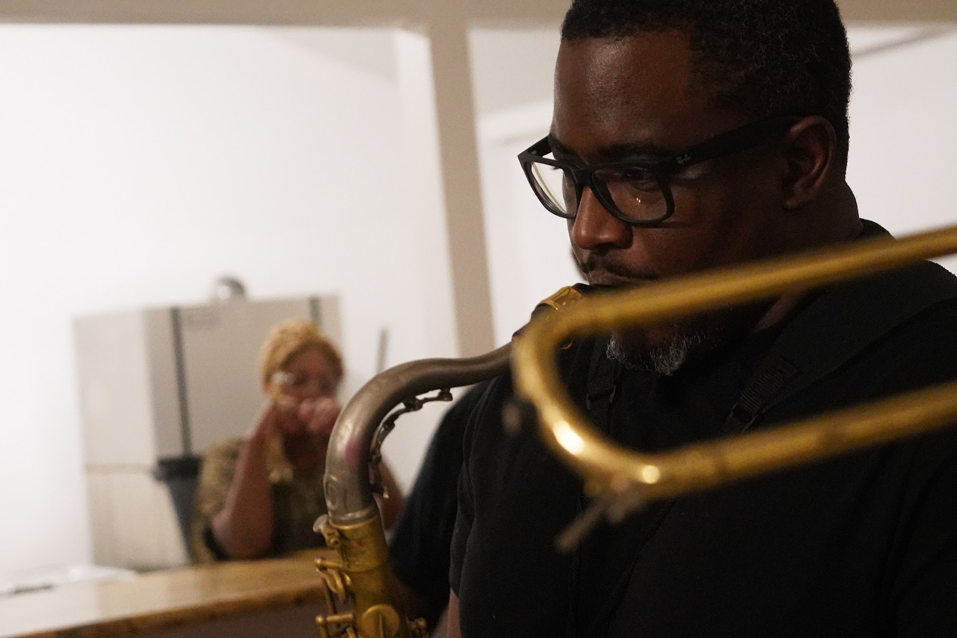 Charae Hosey on trombone — close-up performance shot
