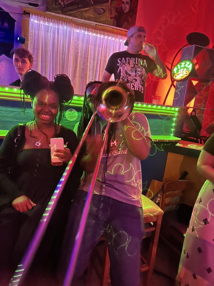 J.A.M. brass band trombone player under neon lights