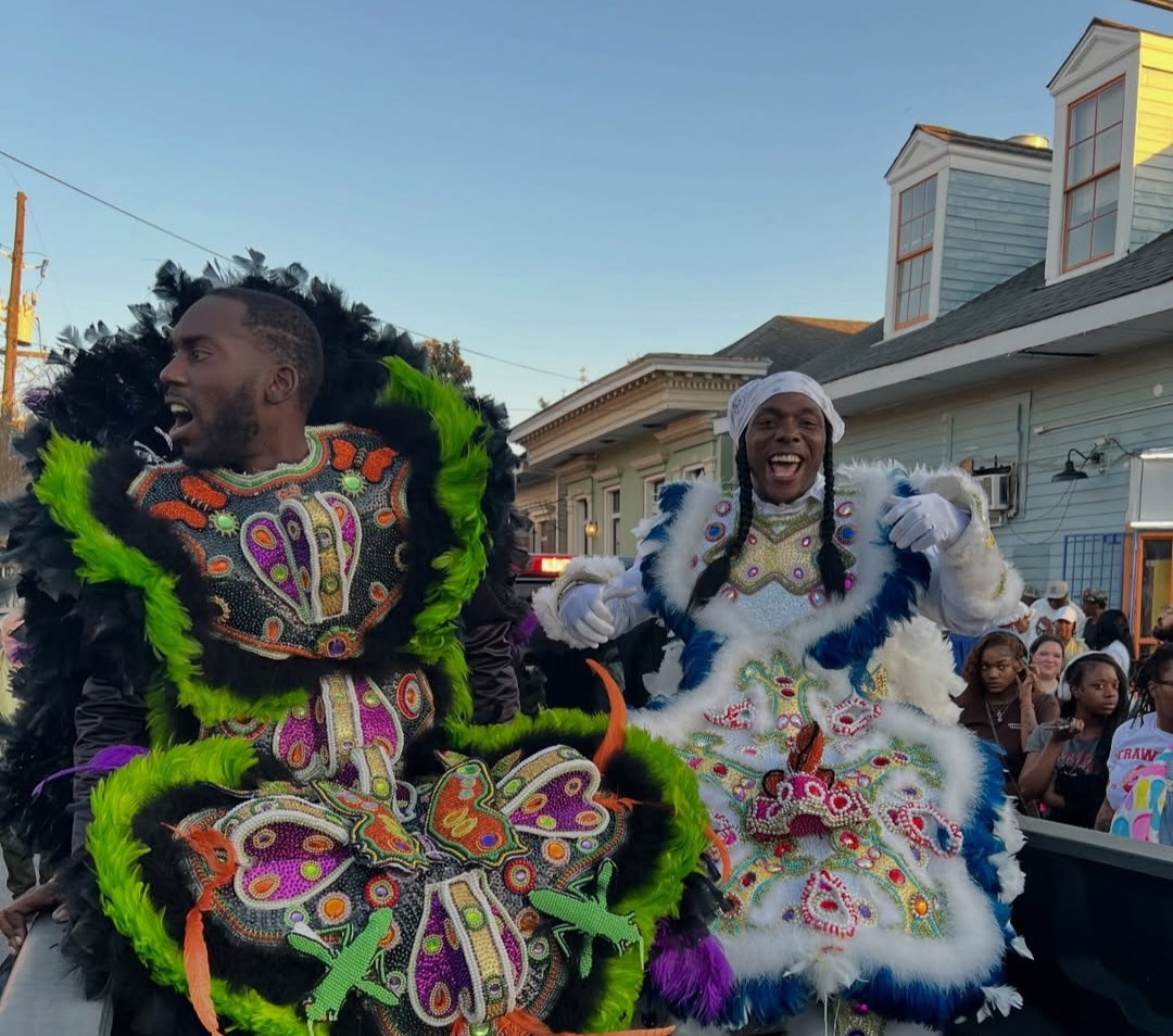Mardi Gras Indians in full regalia at a street celebration